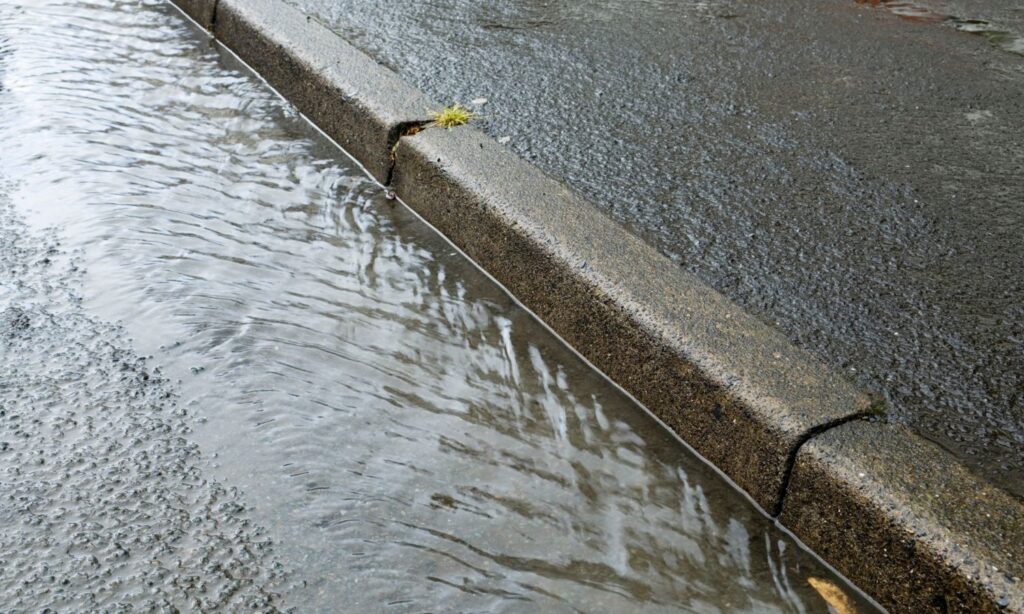Image of water in a gutter showing how Strormwater Runnoff contributes to Nitrate in Groundwater